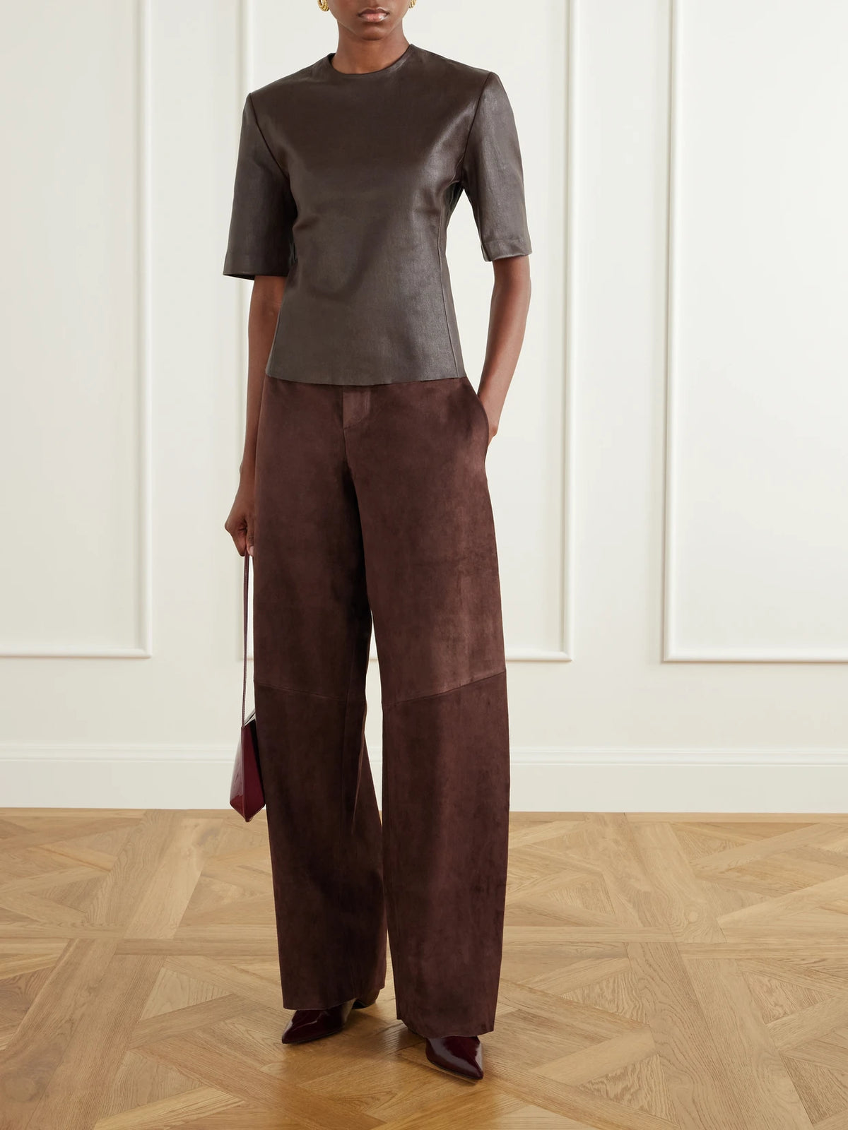Image of a model wearing Pants. Product name - Valadon Paneled Suede Wide-leg Pants in Dark brown colour by brand - STOULS
