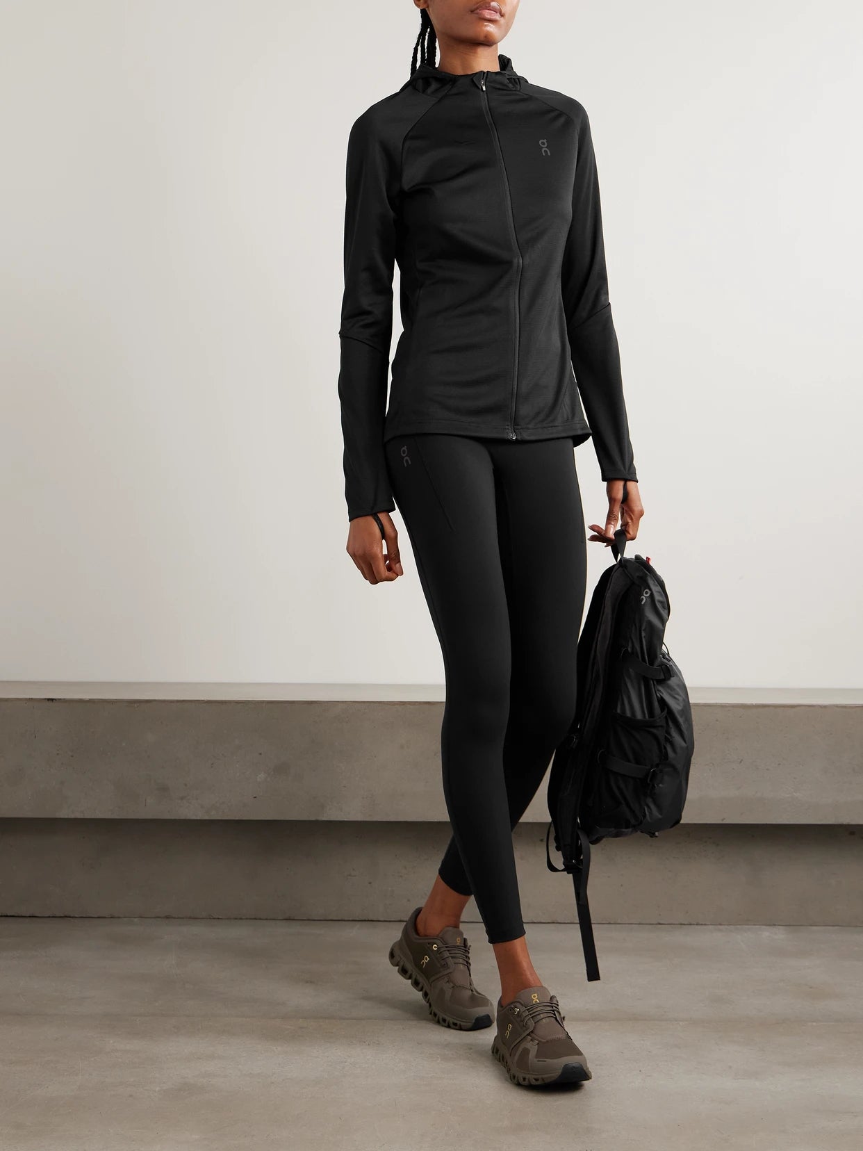 Image of a model wearing Pants. Product name - Performance Paneled Stretch Leggings in Black colour by brand - ON