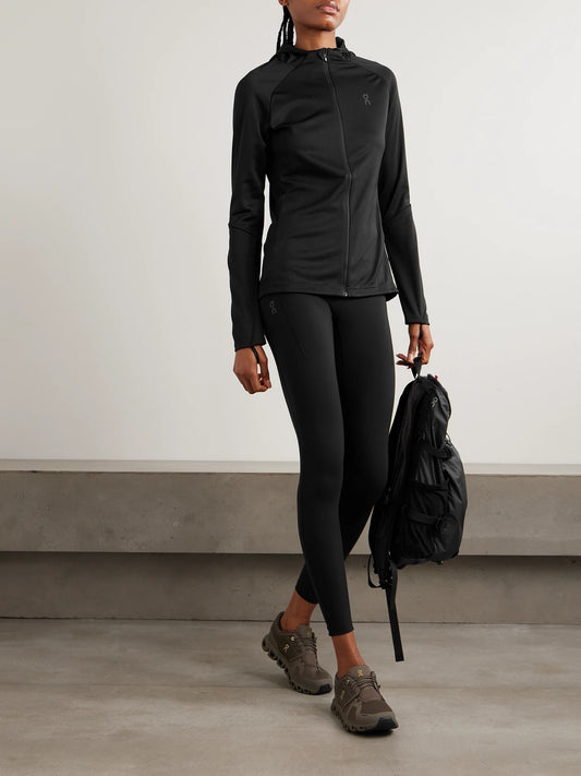 Image of a model wearing Pants. Product name - Performance Paneled Stretch Leggings in Black colour by brand - ON