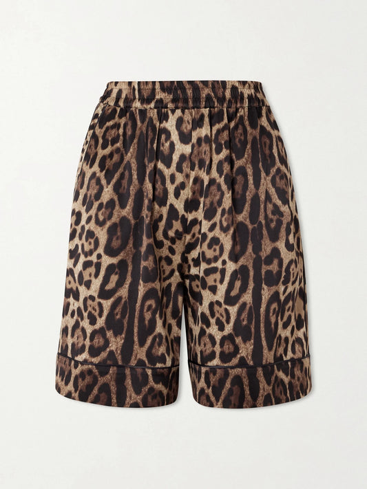 Image of a model wearing Shorts. Product name - Leopard-print Silk-blend Satin Shorts in Leopard print colour by brand - Dolce & Gabbana