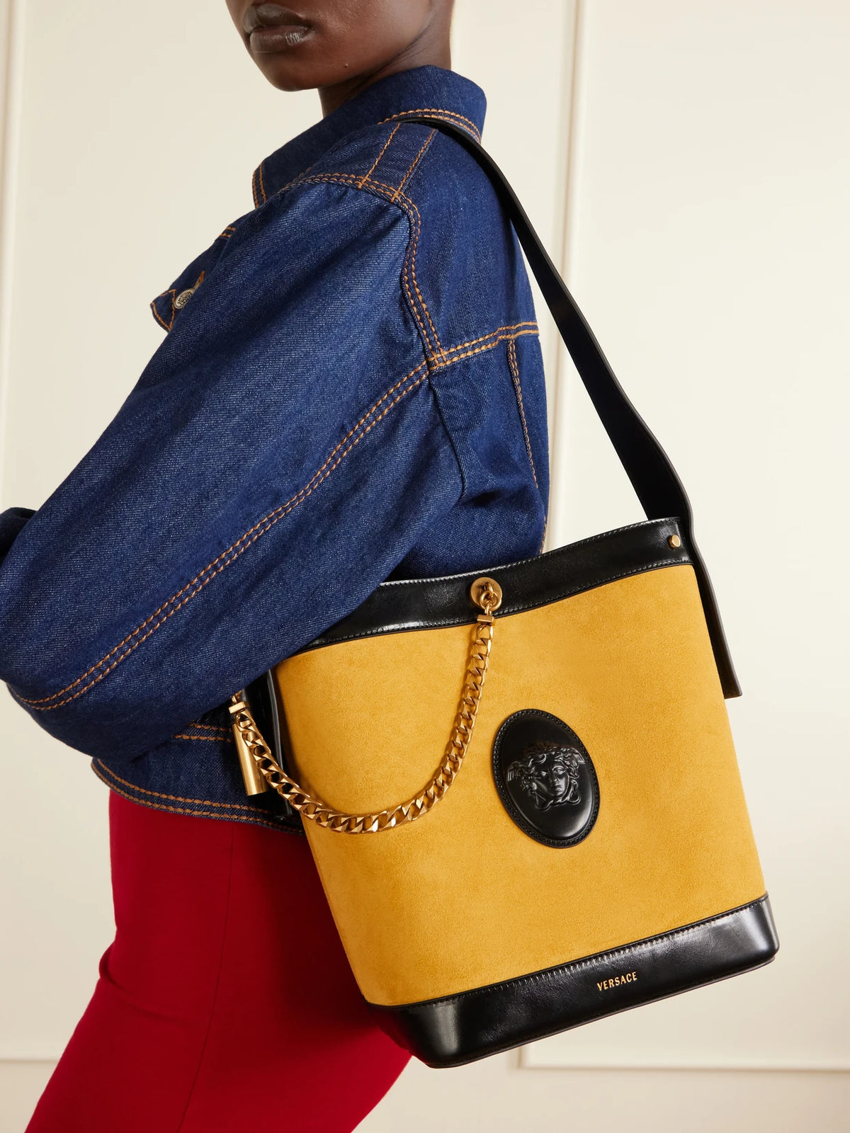 Image of Bags. Product name - Pivot Logo-appliquéd Small Leather Bucket Bag in Mustard colour by brand - Versace