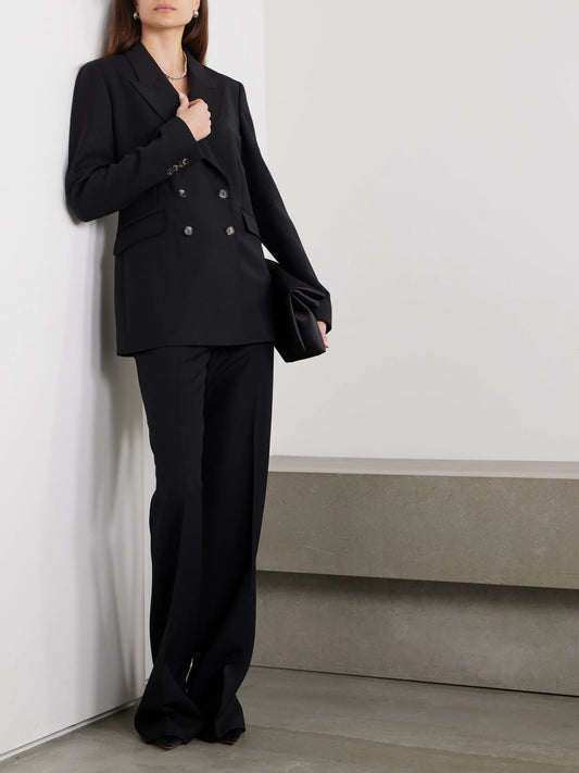 Image of a model wearing Outerwear. Product name - Angela Double-breasted Wool-crepe Blazer in Black colour by brand - Gabriela Hearst