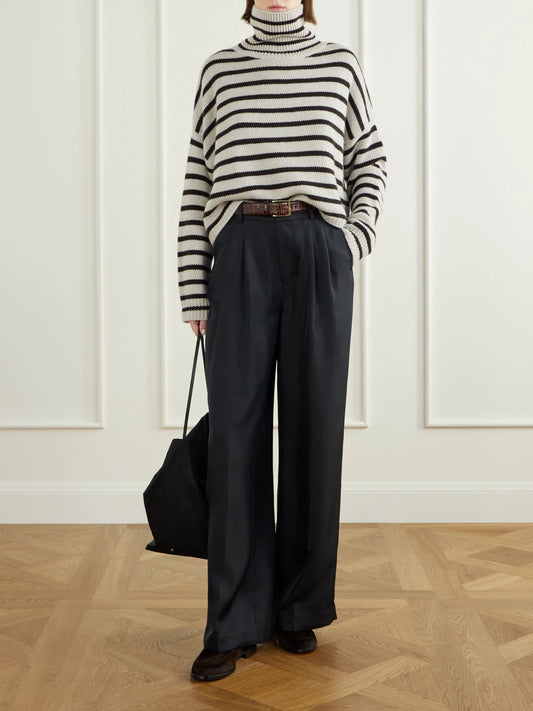 Image of a model wearing Outerwear. Product name - Zerlina Striped Cashmere Turtleneck Sweater in Black colour by brand - LISA YANG