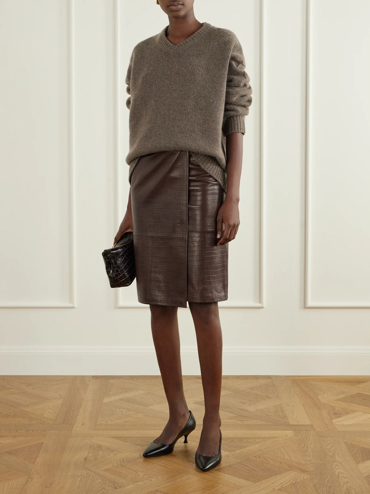 Image of a model wearing Skirts. Product name - Origami Croc-effect Leather Midi Wrap Skirt in Dark brown colour by brand - Nour Hammour
