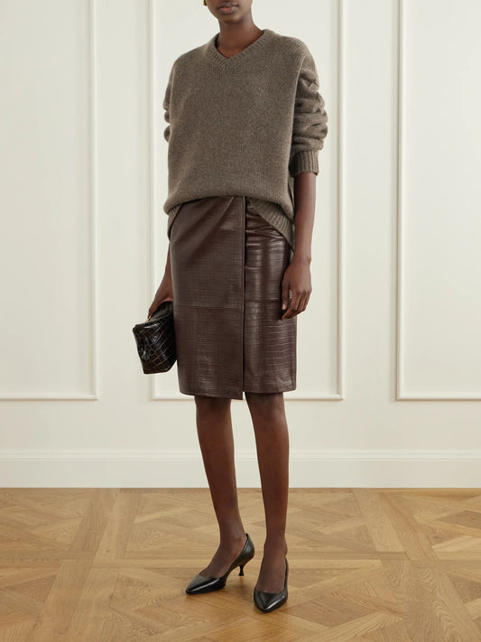 Image of a model wearing Skirts. Product name - Origami Croc-effect Leather Midi Wrap Skirt in Dark brown colour by brand - Nour Hammour