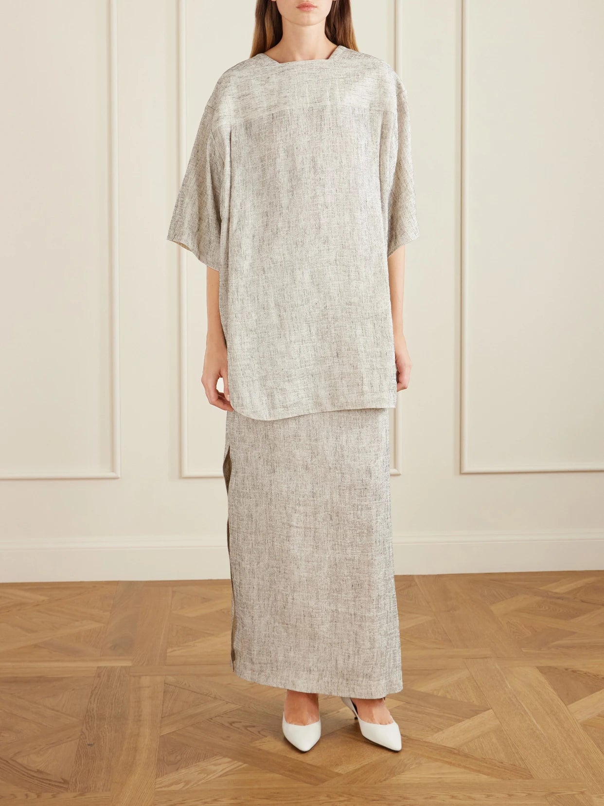 Image of a model wearing Skirts. Product name - Blum Linen And Silk-blend Gauze Midi Skirt in Gray colour by brand - The Row