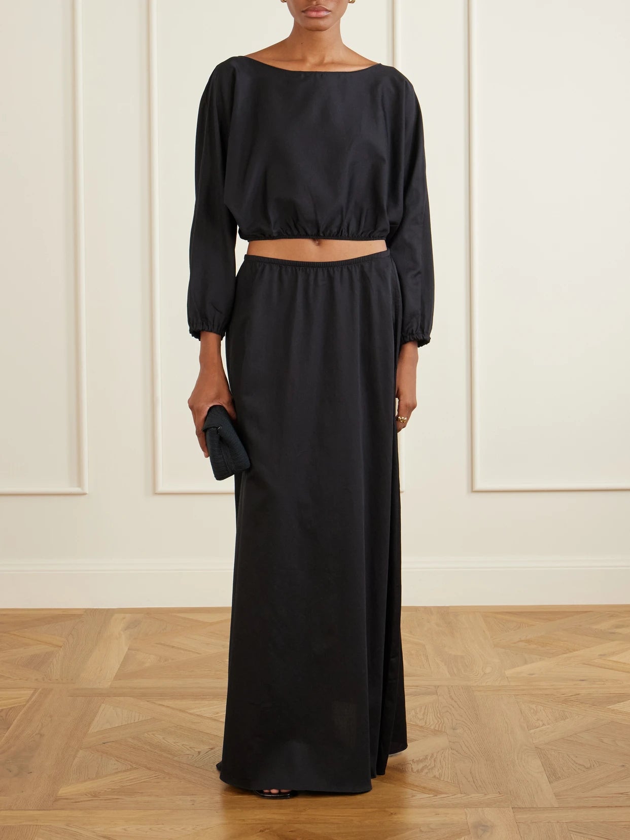Image of a model wearing Tops. Product name - Yoko Cropped Gathered Cotton-poplin Top in Black colour by brand - LESET