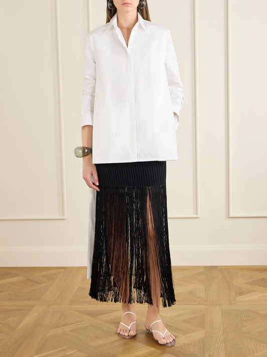 Image of a model wearing Skirts. Product name - Ribbed Fringed Jersey Midi Skirt in Black colour by brand - Alaïa