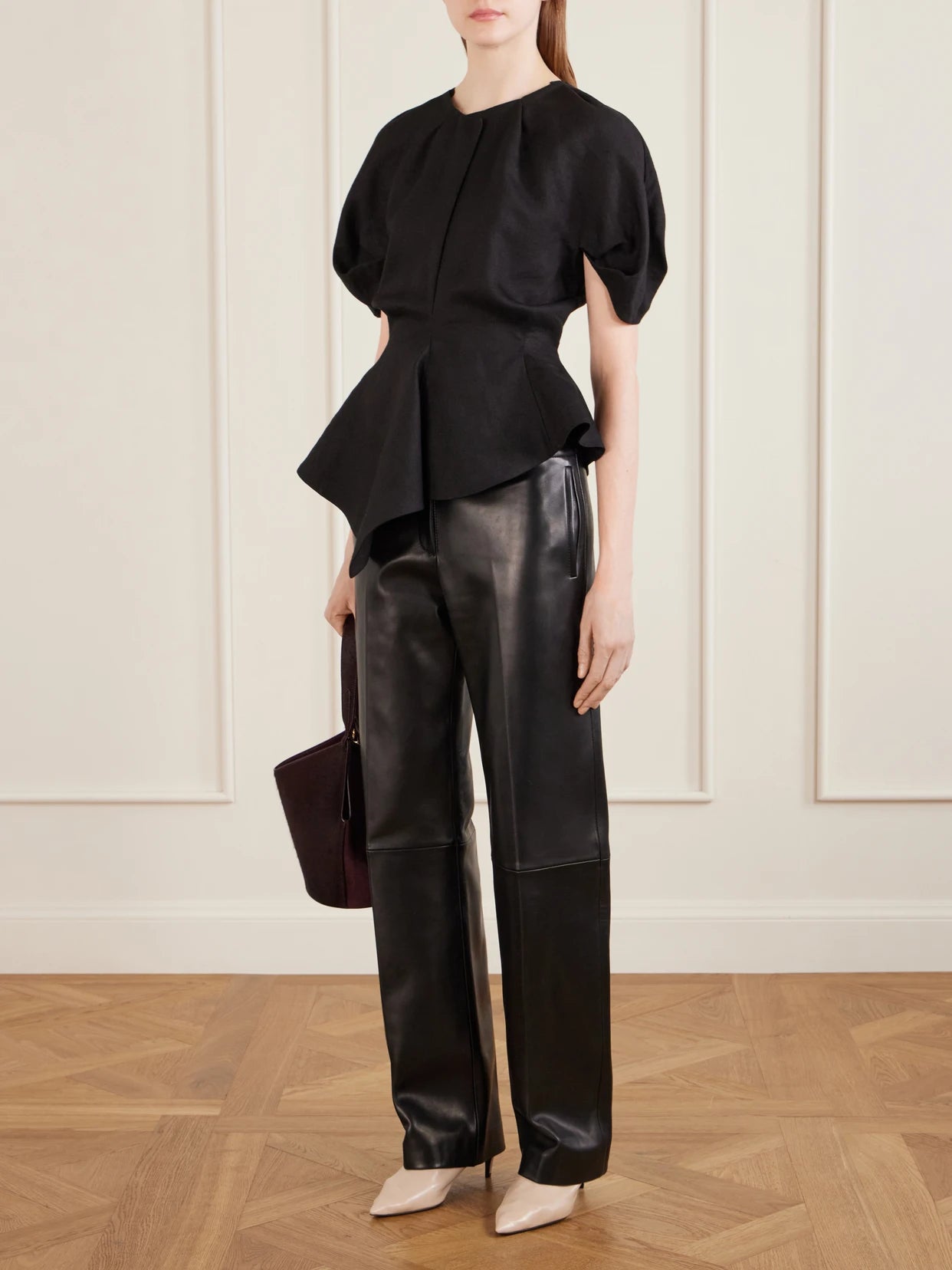 Image of a model wearing Tops. Product name - Rumi Linen-blend Blouse in Black colour by brand - KHAITE