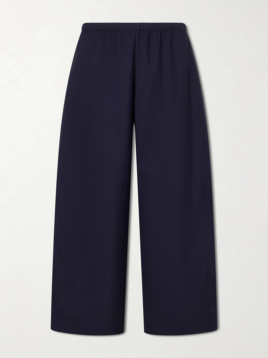 Image of a model wearing Pants. Product name - Roma Wool High-waist Wide-leg Pants in Navy colour by brand - KHAITE