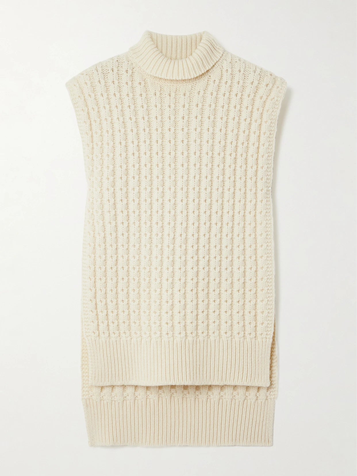 Image of a model wearing Outerwear. Product name - Oversized Belted Ribbed Wool Turtleneck Sweater Vest in Ivory colour by brand - Alaïa