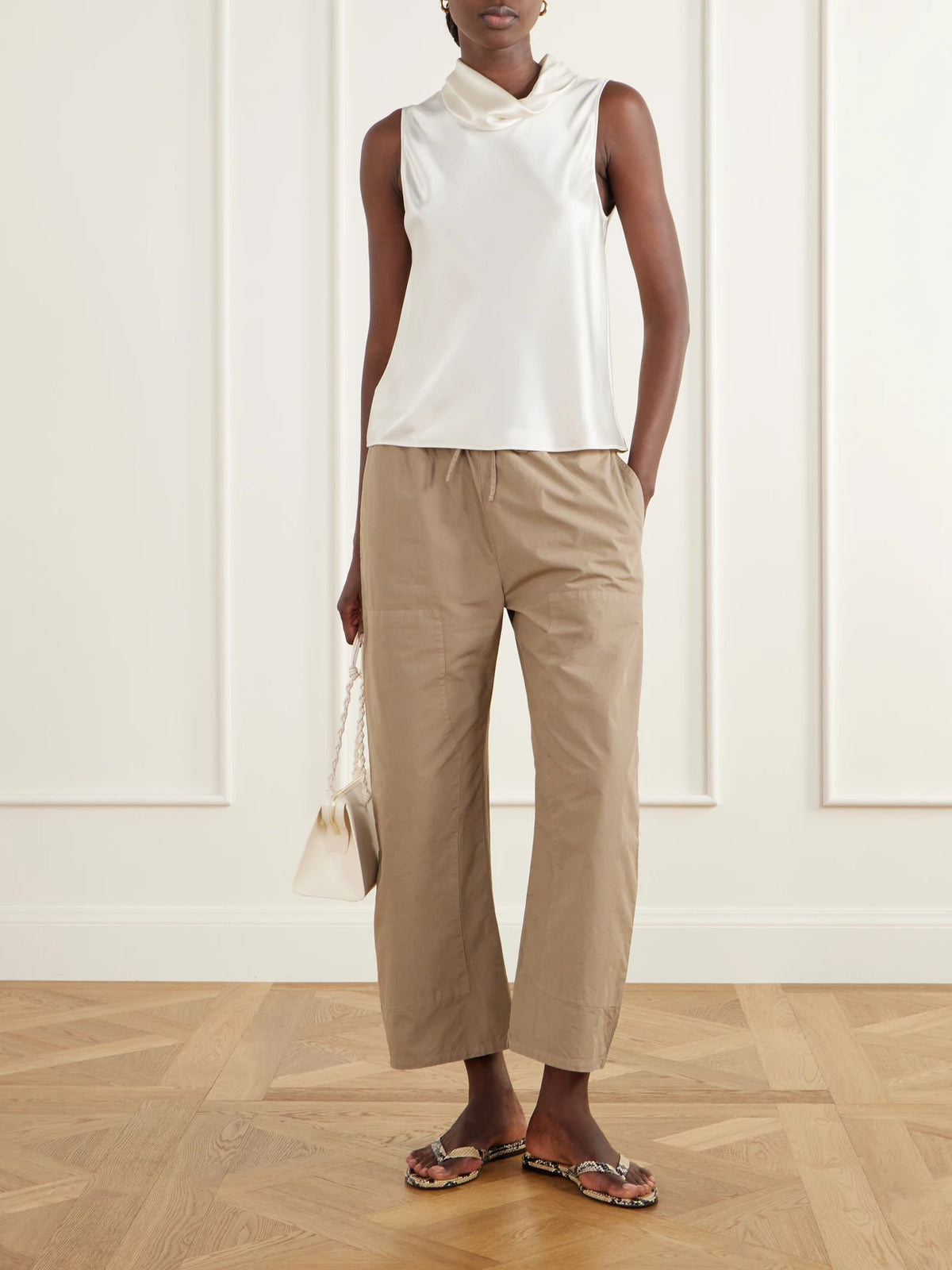 Image of a model wearing Pants. Product name - Kyoto Drawstring Cotton-poplin Barrel-leg Pants in Light brown colour by brand - LESET