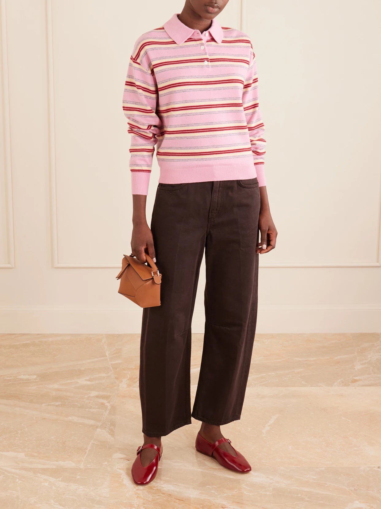 Image of a model wearing Outerwear. Product name - Collegiate Striped Cashmere Polo Sweater in Pink colour by brand - Guest In Residence