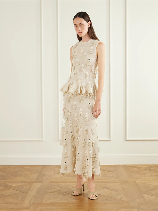 Image of a model wearing Skirts. Product name - Jane Fringed-embellished Cotton Crochet-knit Midi Skirt in Cream colour by brand - Yoshita 1967
