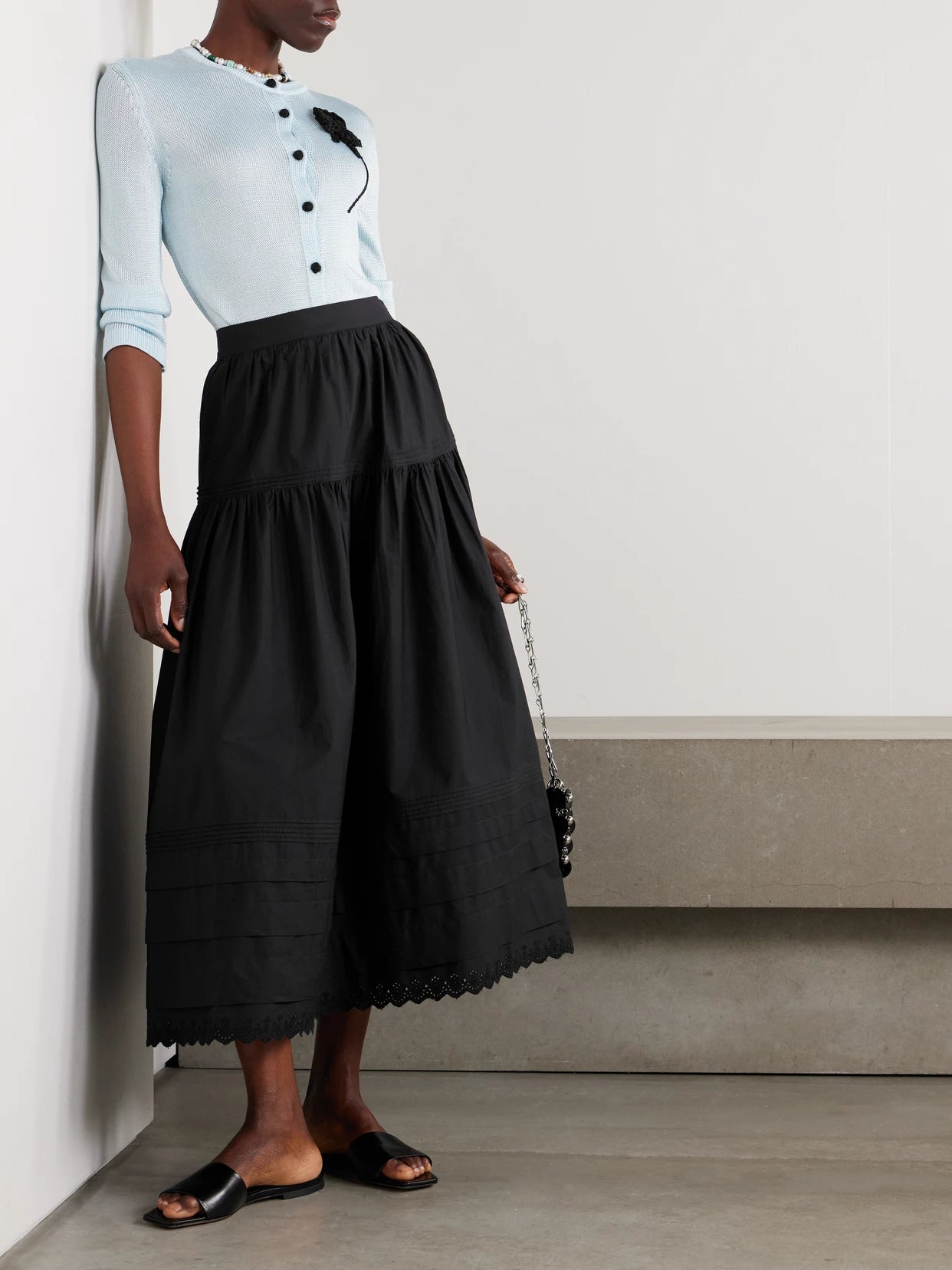 Image of a model wearing Skirts. Product name - Sebastiane Crochet-trimmed Organic Cotton-poplin Midi Skirt in Black colour by brand - DÔEN