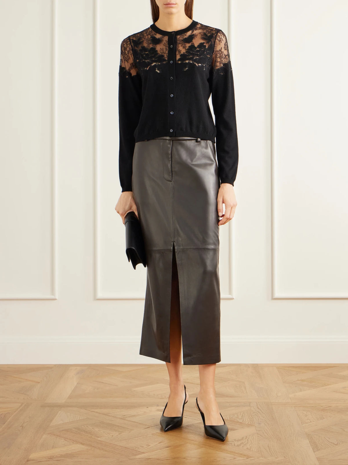 Image of a model wearing Outerwear. Product name - Talia Lace-trimmed Merino Wool Cardigan in Black colour by brand - Ulla Johnson