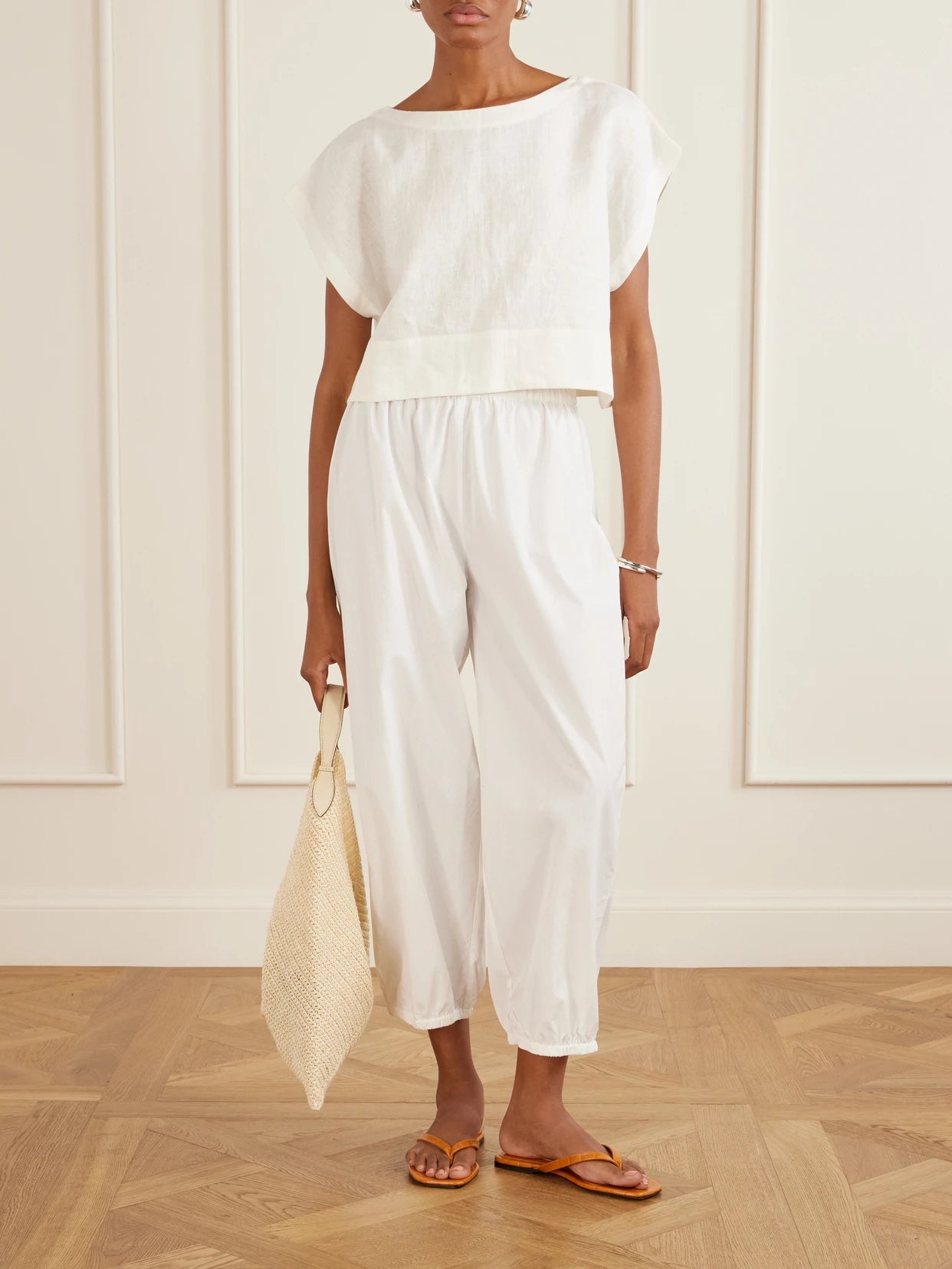 Image of a model wearing Pants. Product name - Delos Cotton-poplin Balloon Pants in White colour by brand - Suzie Kondi