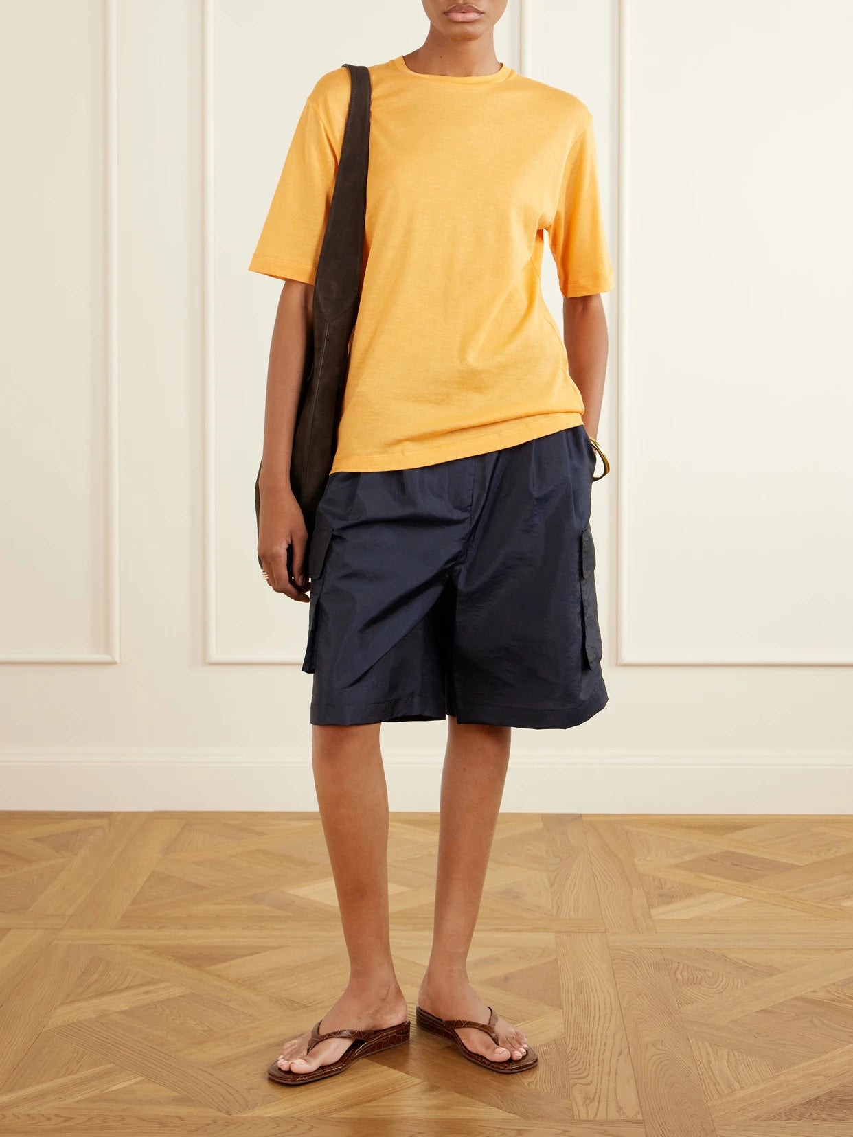 Image of a model wearing Tops. Product name - Cotton-knit T-shirt in Orange colour by brand - Tibi