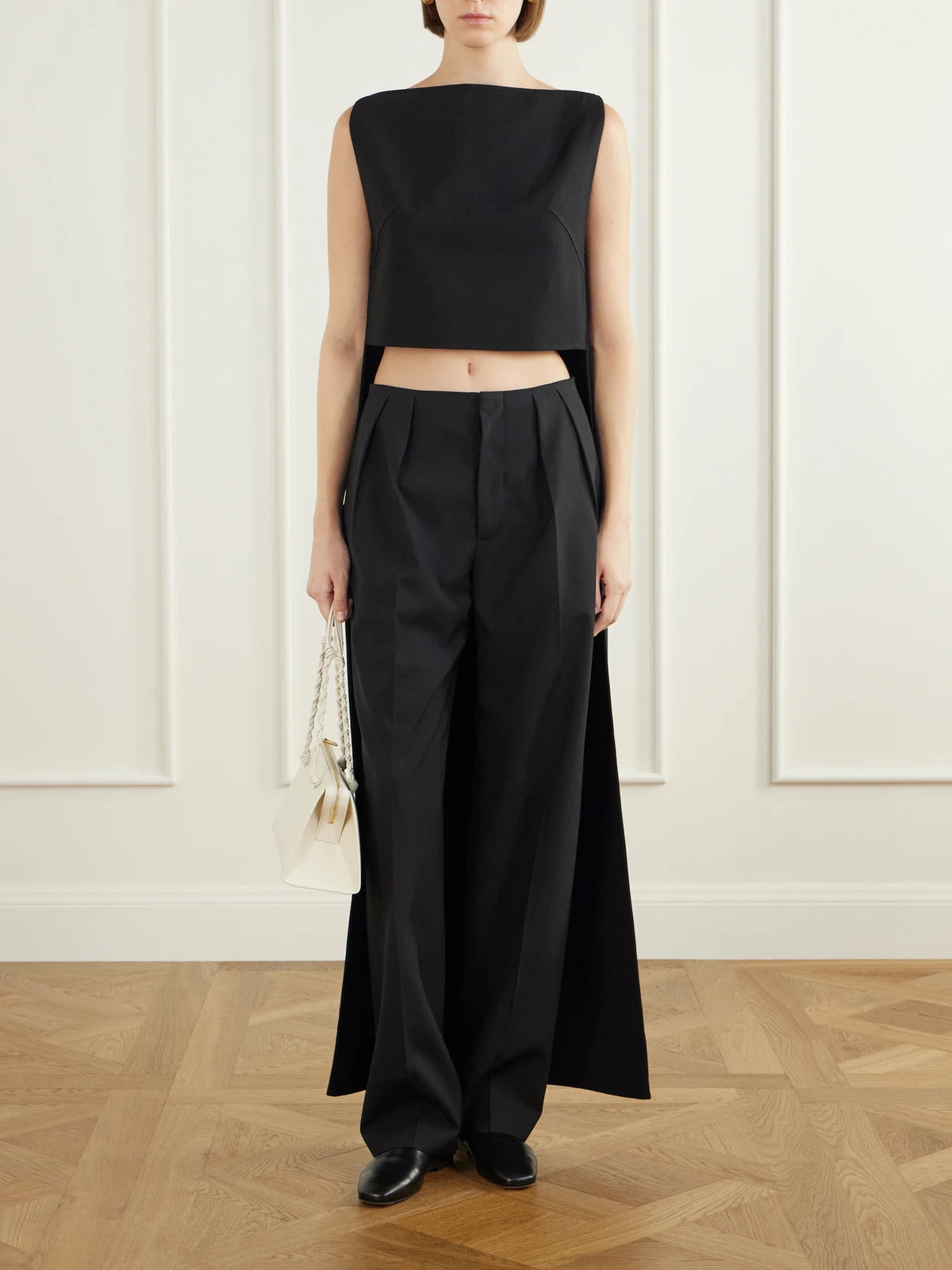 Image of a model wearing Tops. Product name - Cropped Wool-blend Blouse in Black colour by brand - Jil Sander