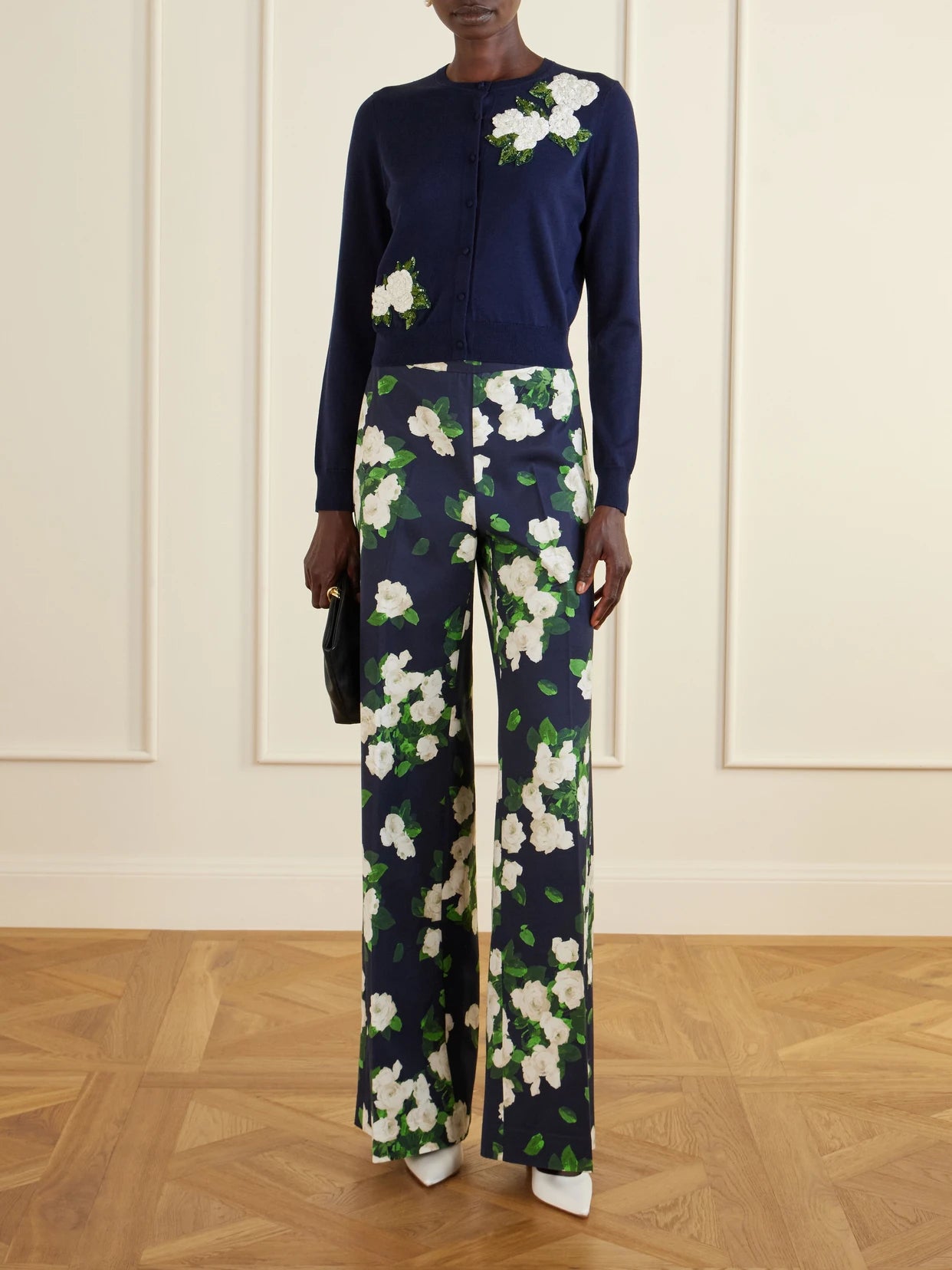 Image of a model wearing Pants. Product name - Diane Floral-print High-rise Cotton-blend Wide-leg Pants in Navy colour by brand - Carolina Herrera