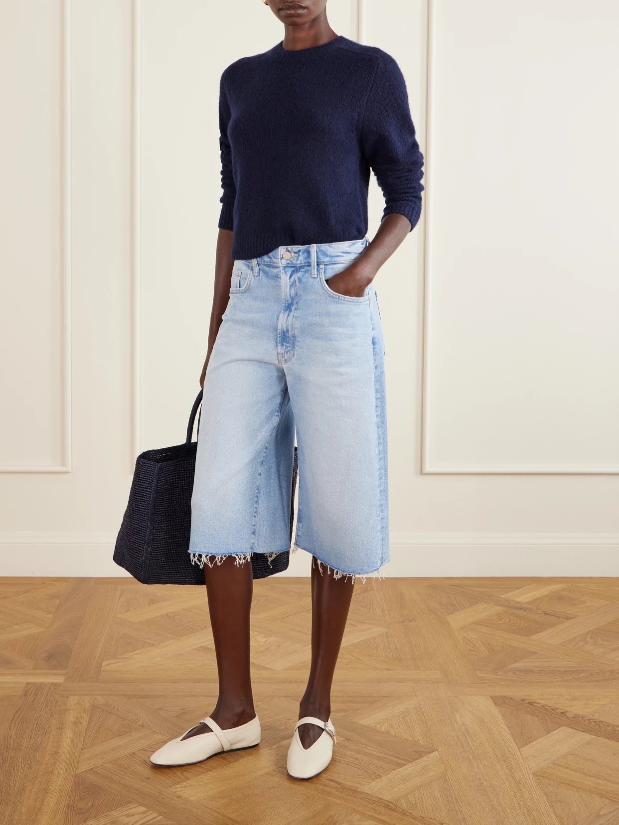 Image of a model wearing Shorts. Product name - The Whole Lot Zip Fray Low-rise Wide-leg Denim Shorts in Light denim colour by brand - Mother