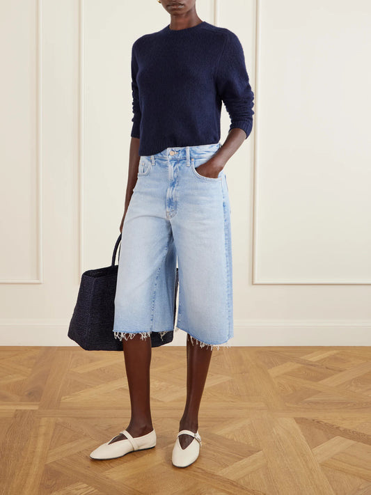 Image of a model wearing Shorts. Product name - The Whole Lot Zip Fray Low-rise Wide-leg Denim Shorts in Light denim colour by brand - Mother