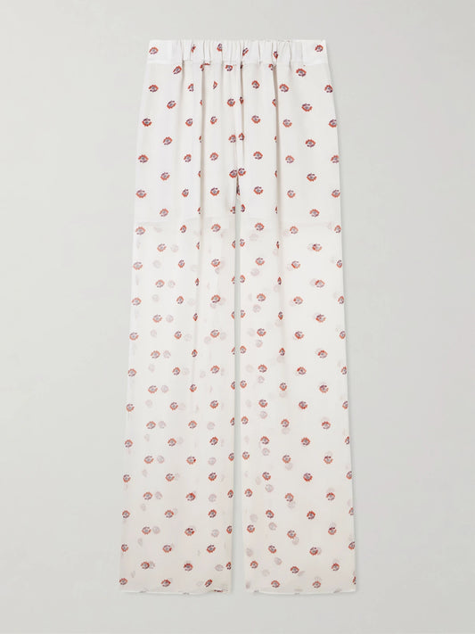 Image of a model wearing Pants. Product name - Palazzo Floral-print Wide-leg Silk Pants in White colour by brand - LIBEROWE