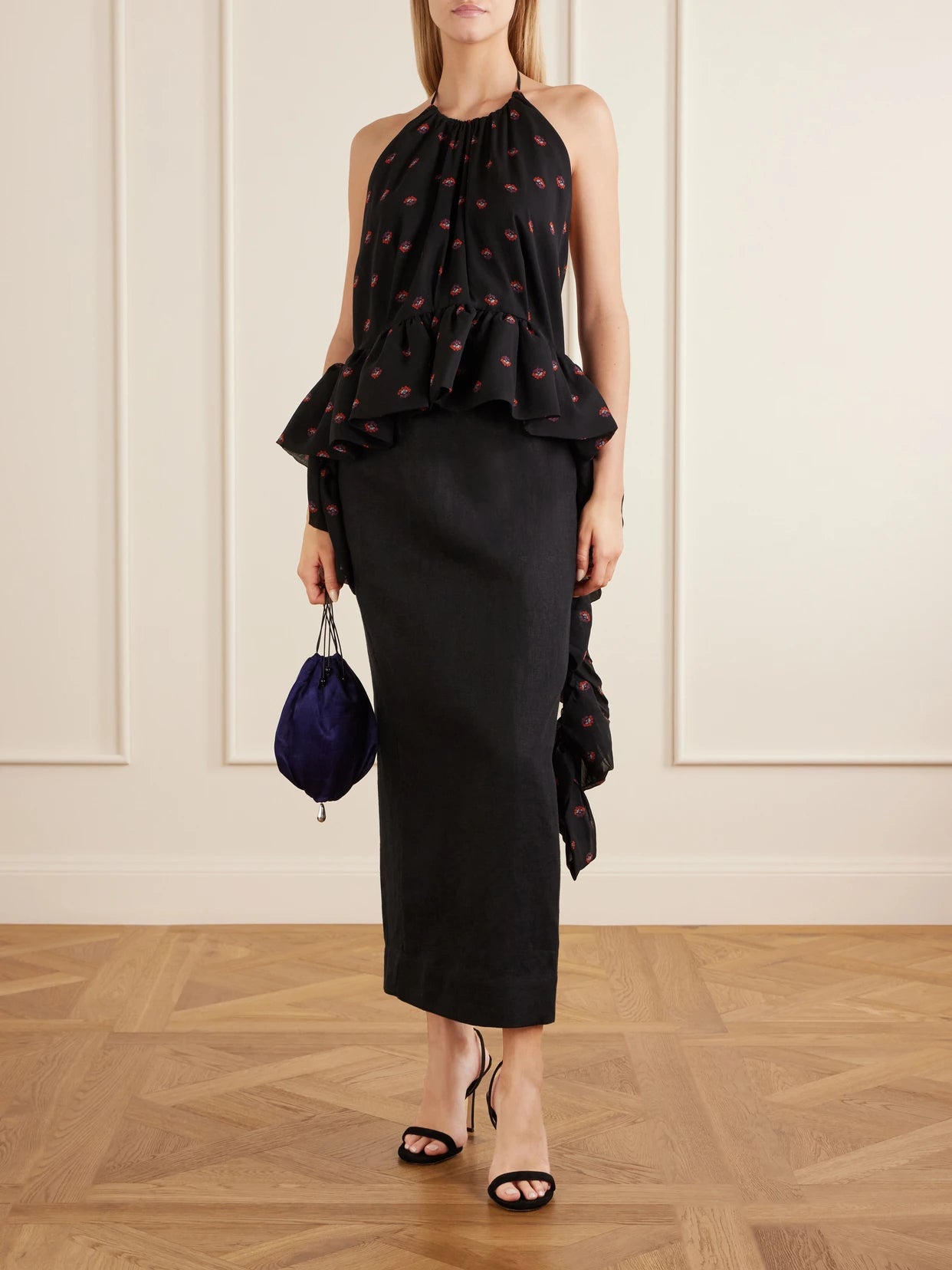 Image of a model wearing Tops. Product name - Tamara Printed Silk-chiffon Peplum Blouse in Black colour by brand - LIBEROWE