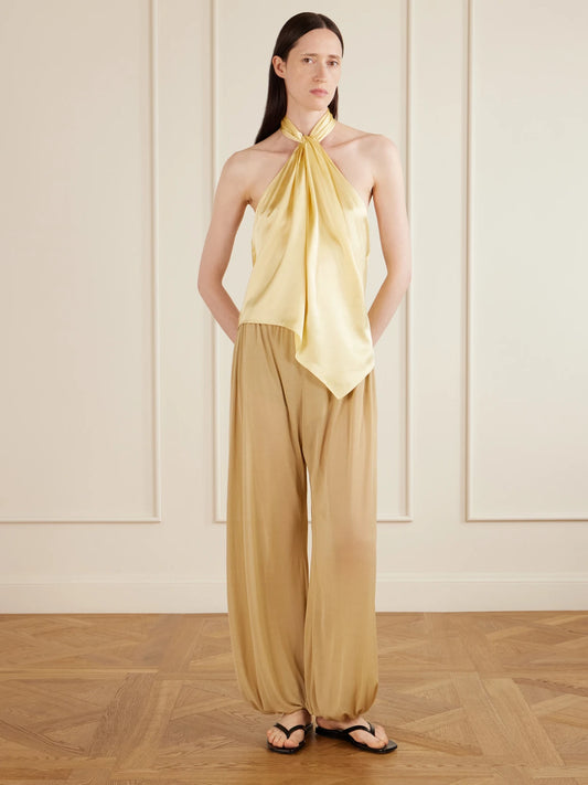 Image of a model wearing Pants. Product name - Lolana Satin-jersey Balloon Pants in Ecru, Ivory, Black colour by brand - AFLALO