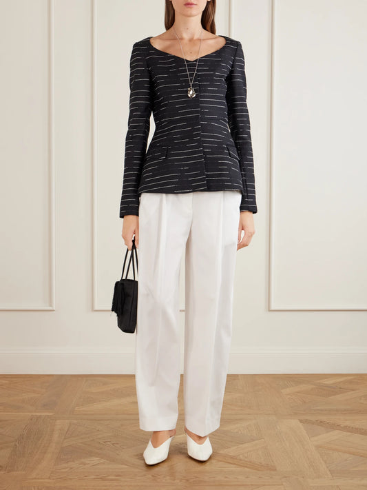 Image of a model wearing Tops. Product name - Charlotte Striped Wool-gabardine Blouse in Black colour by brand - LIBEROWE