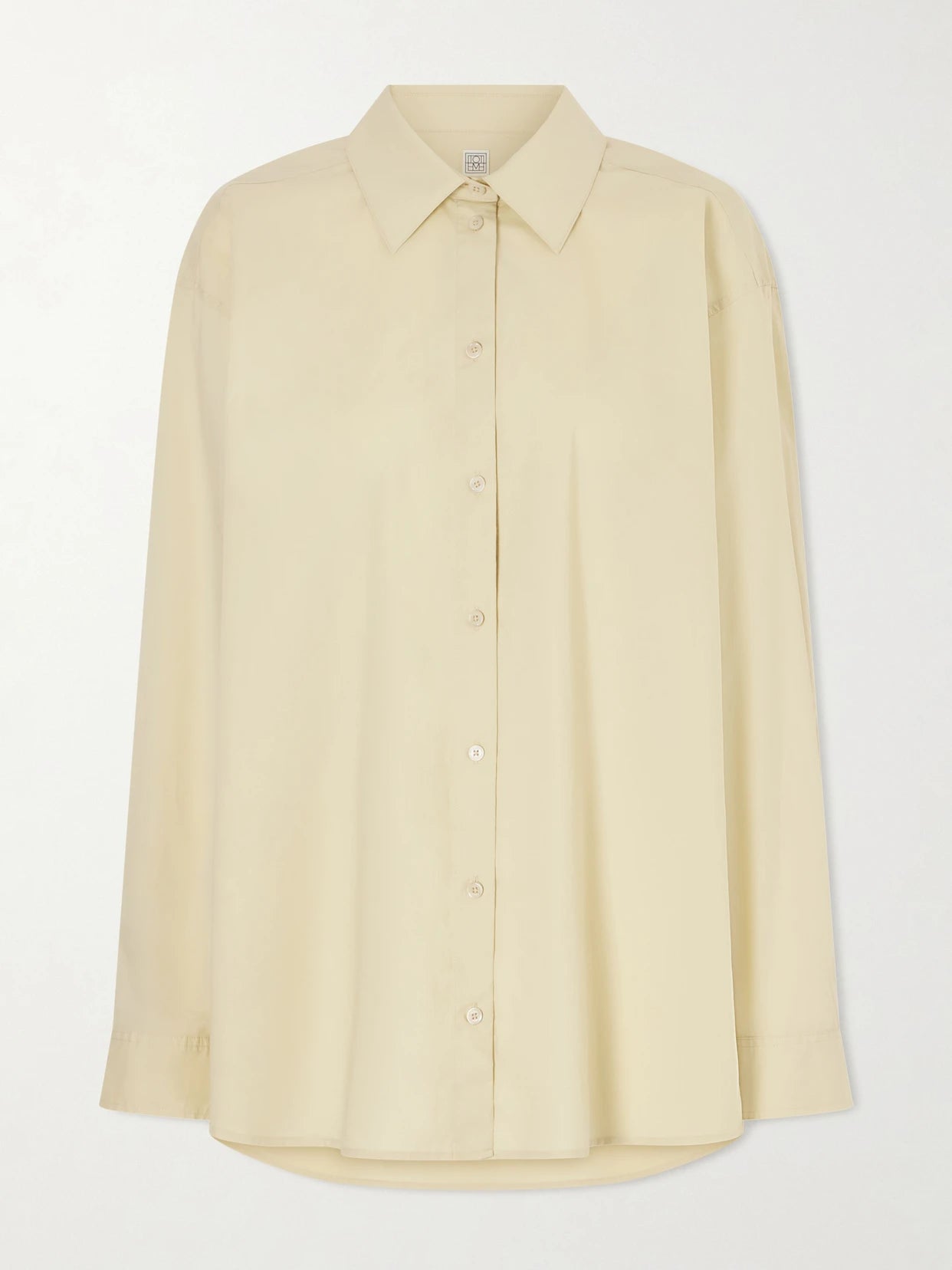 Image of a model wearing Tops. Product name - Cotton Shirt in Cream colour by brand - TOTEME