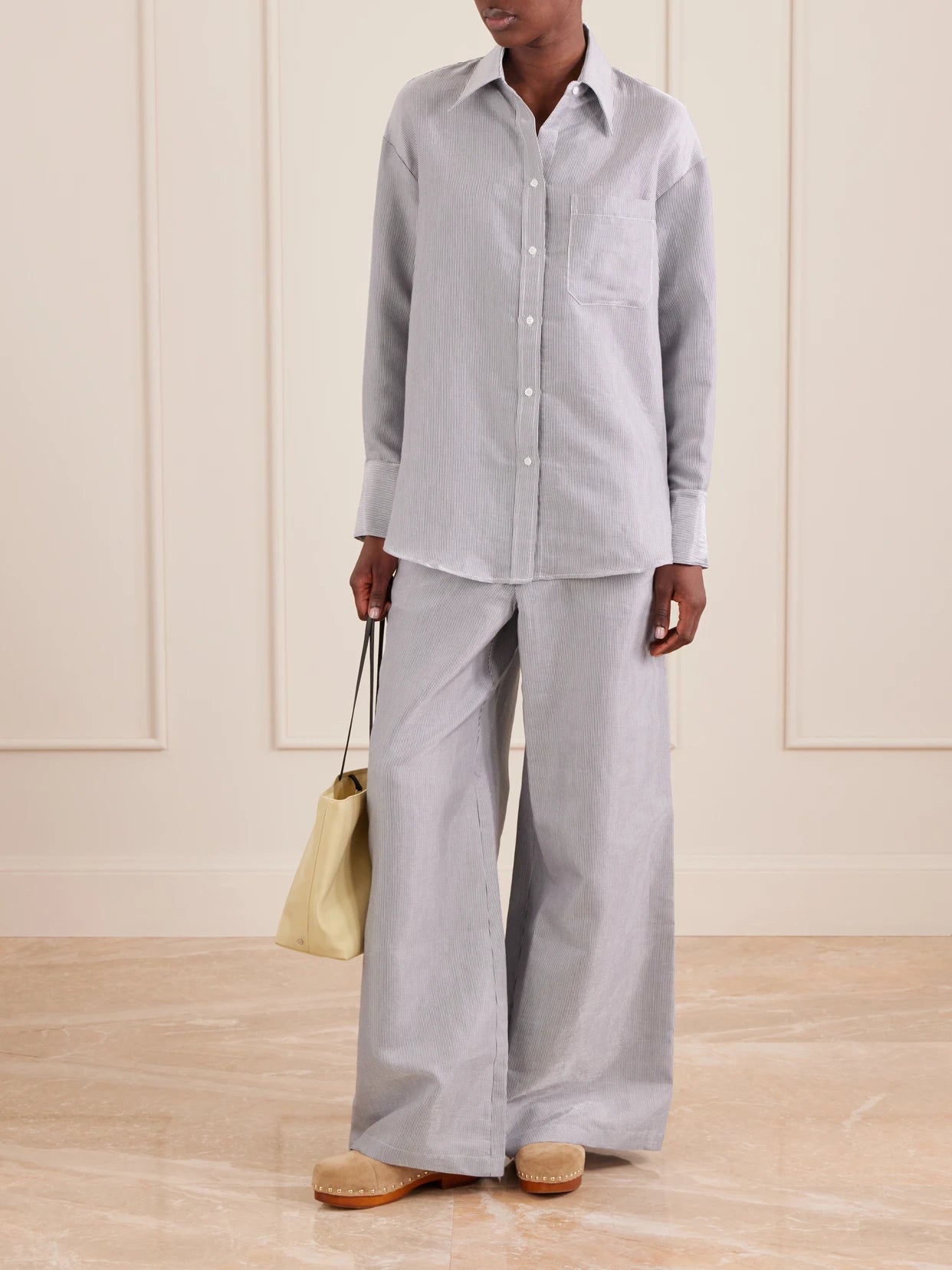 Image of a model wearing Pants. Product name - Dylan Striped Cotton-blend Gabardine Wide-leg Pants in Multi colour by brand - TWP