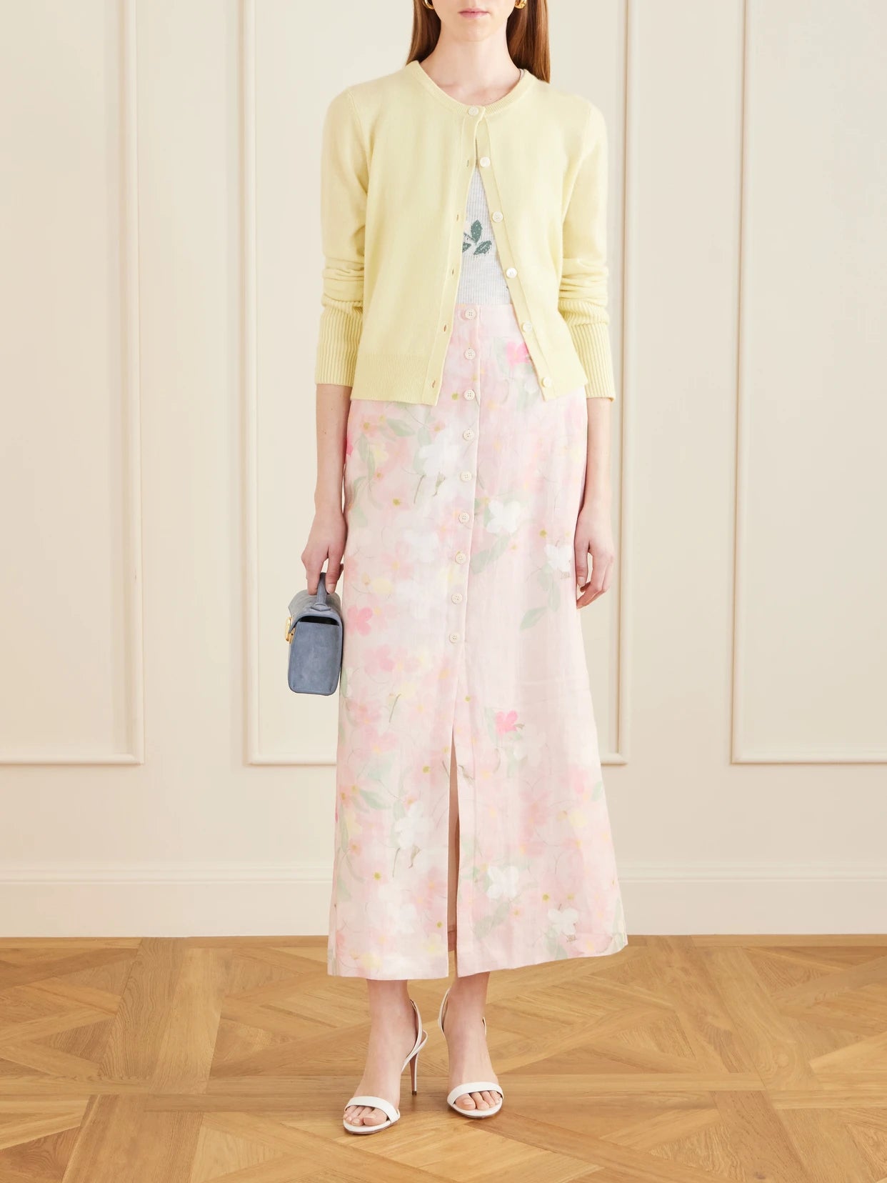 Image of a model wearing Skirts. Product name - Carmen Floral-printed Linen Midi Skirt in Pink colour by brand - BERNADETTE
