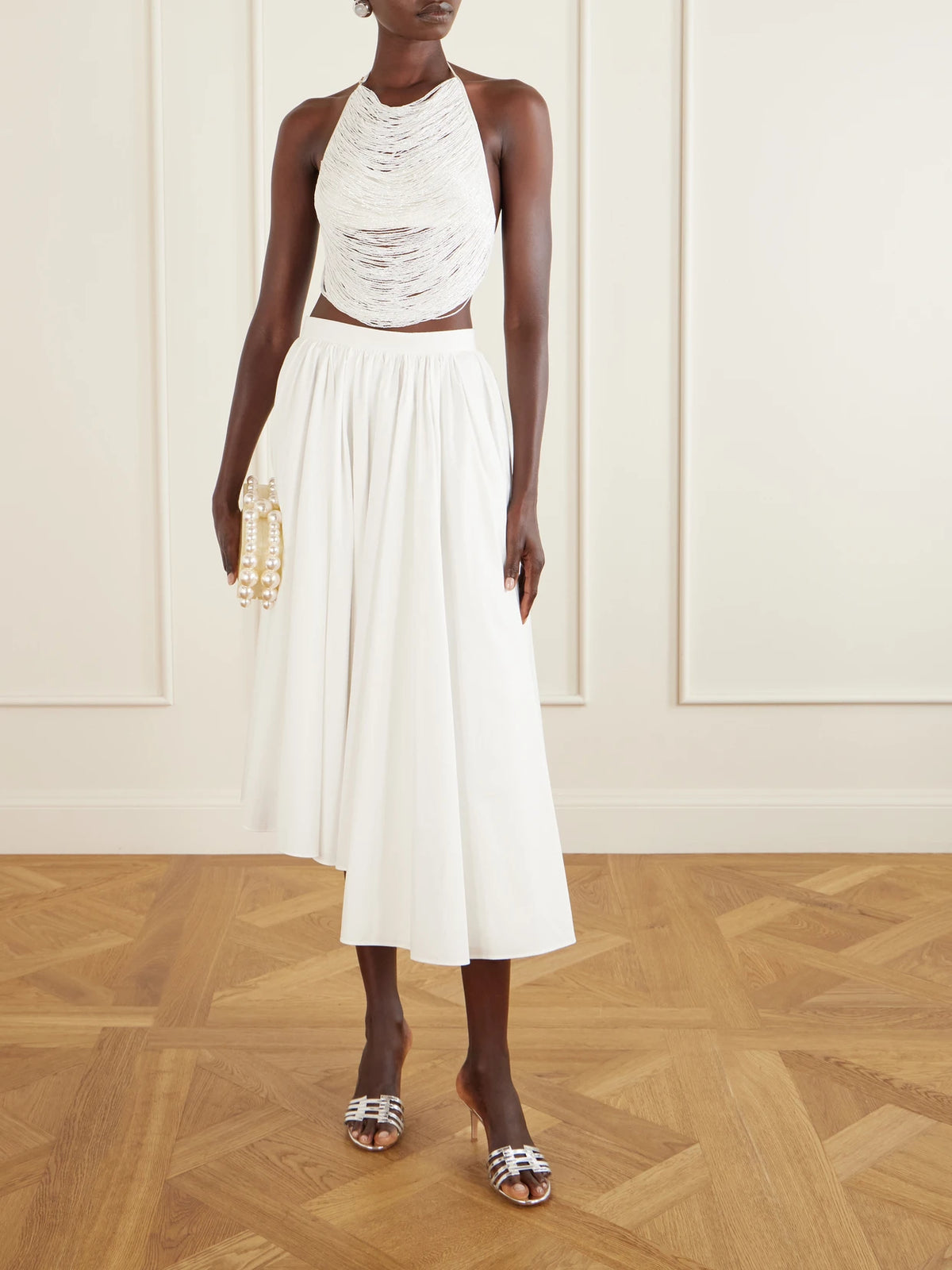 Image of a model wearing Tops. Product name - Tanner Bead-embellished Silk-blend Satin Tank in Off-white colour by brand - Cult Gaia