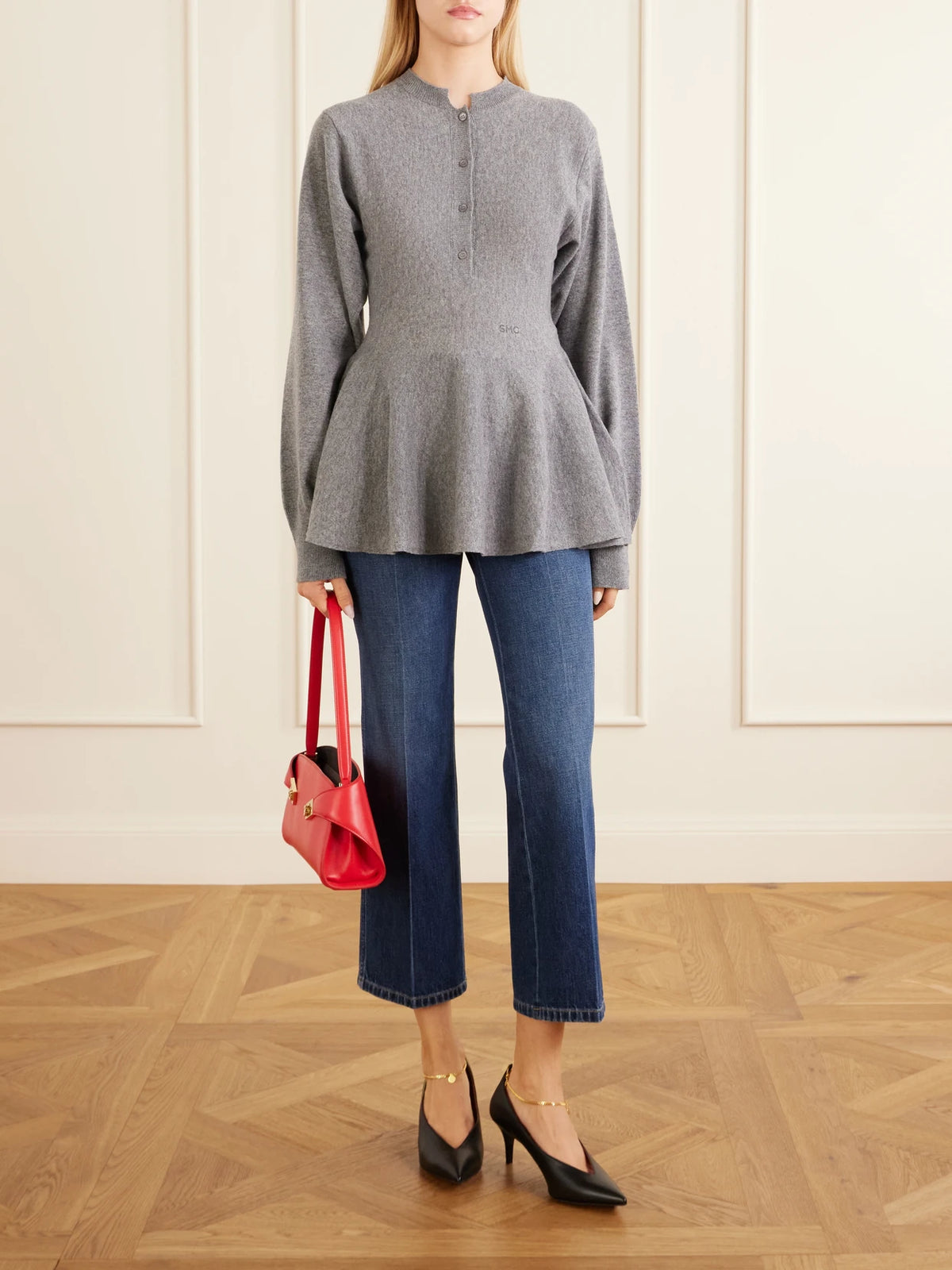 Image of a model wearing Outerwear. Product name - Wool Peplum Sweater in Gray colour by brand - Stella McCartney