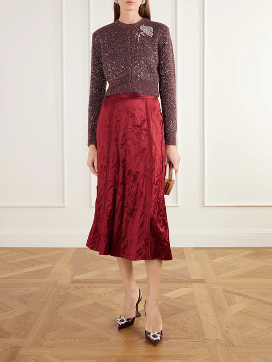 Image of a model wearing Skirts. Product name - Crystal-embellished Crinkled-satin Midi Skirt in Red colour by brand - Erdem