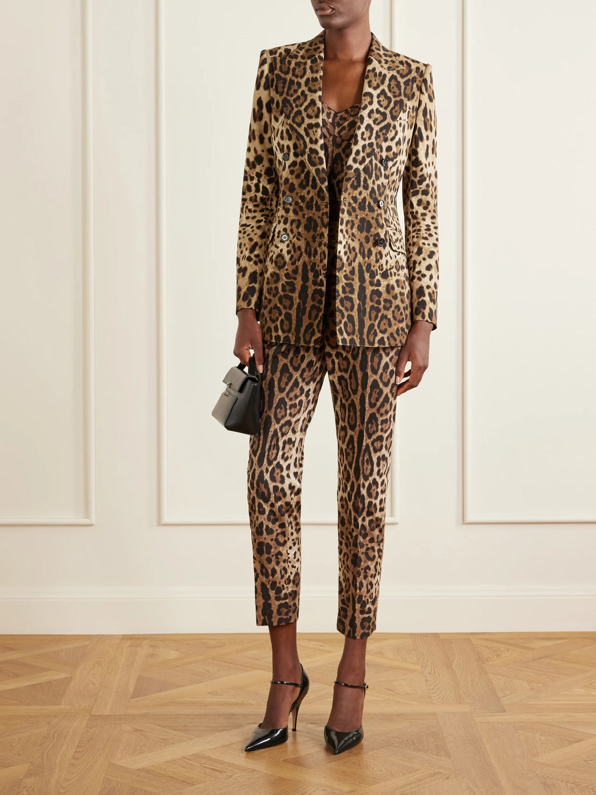 Image of a model wearing Pants. Product name - Leopard-print High-rise Cotton Straight-leg Pants in Leopard print colour by brand - Dolce & Gabbana