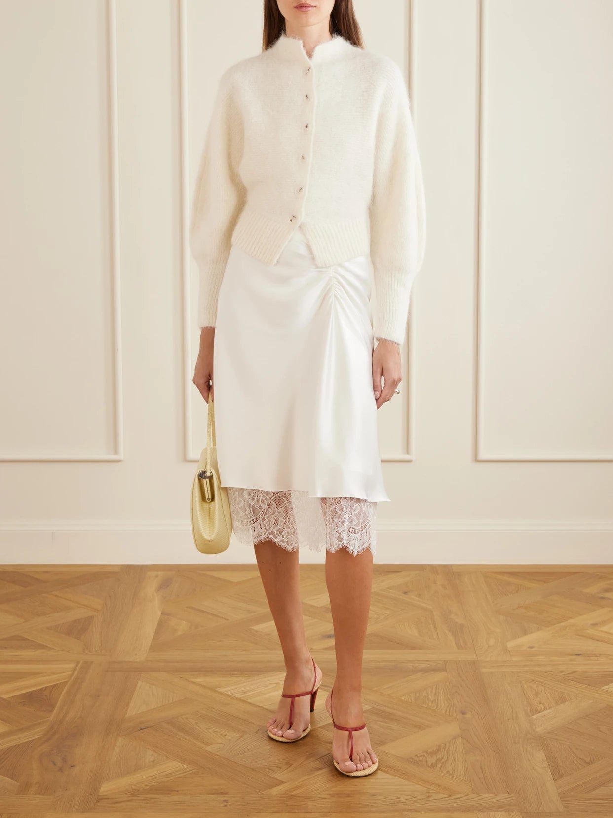 Image of a model wearing Skirts. Product name - Ingrid Layered Gathered Lace-trimmed Satin Midi Skirt in Ivory colour by brand - SIR.