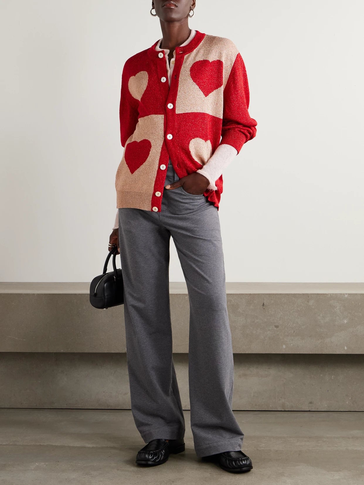Image of a model wearing Outerwear. Product name - Two-tone Lamé Cardigan in Red colour by brand - BODE