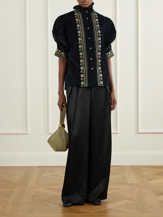 Image of a model wearing Tops. Product name - Vita Embroidered Cotton And Wool-blend Corduroy Blouse in Black colour by brand - Thierry Colson