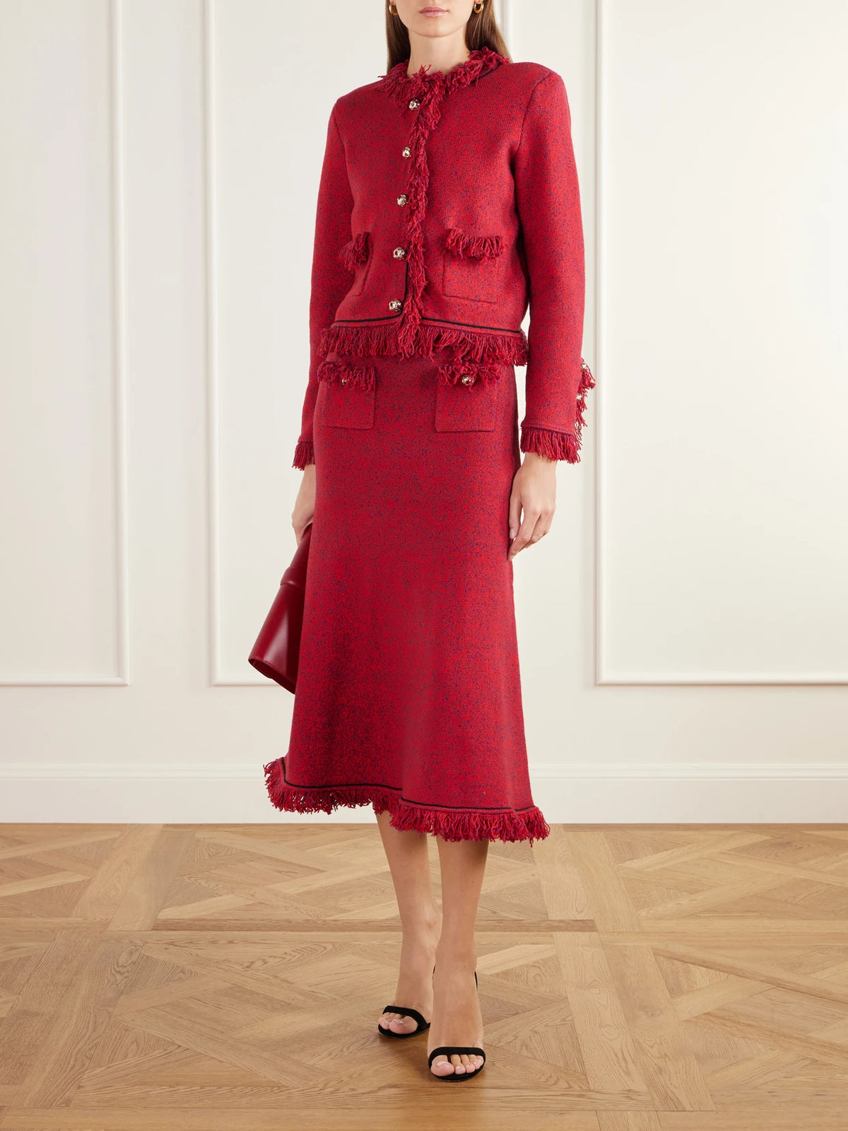 Image of a model wearing Skirts. Product name - Frayed Bouclé-knit Midi Skirt in Red colour by brand - Self-Portrait