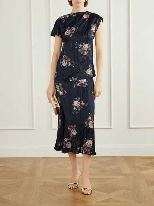 Image of a model wearing Tops. Product name - Asymmetric Draped Floral-print Metallic Crinkled-satin Blouse in Black colour by brand - Erdem