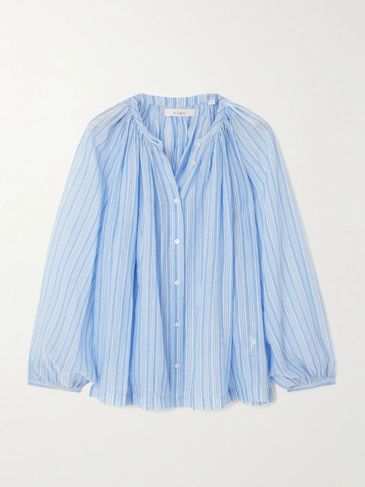 Image of a model wearing Tops. Product name - Jonie Striped Organic Cotton-voile Blouse in Blue colour by brand - DÔEN