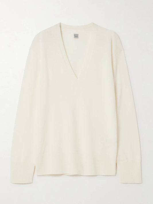 Image of a model wearing Outerwear. Product name - Garderob Cashmere Sweater in Ecru colour by brand - TOTEME