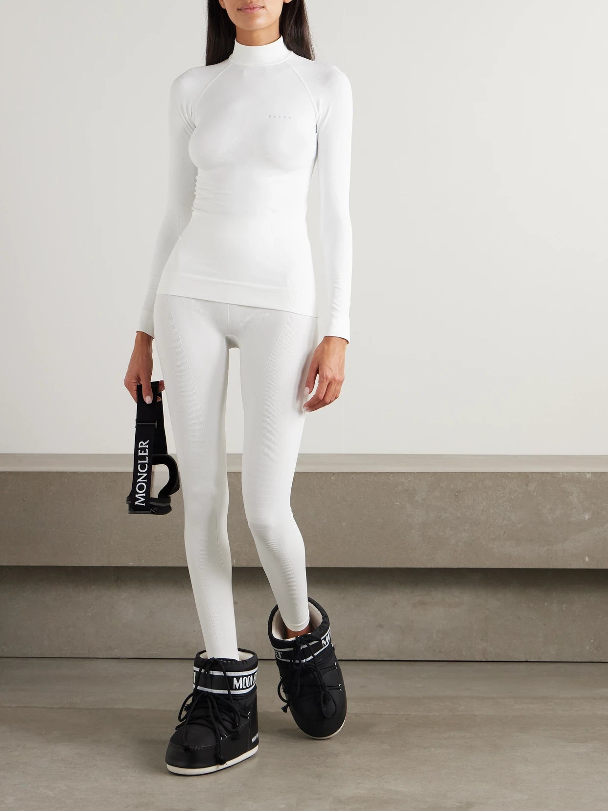 Image of a model wearing Tops. Product name - Maximum Warm Stretch-jersey Turtleneck Top in White colour by brand - FALKE Ergonomic Sport System