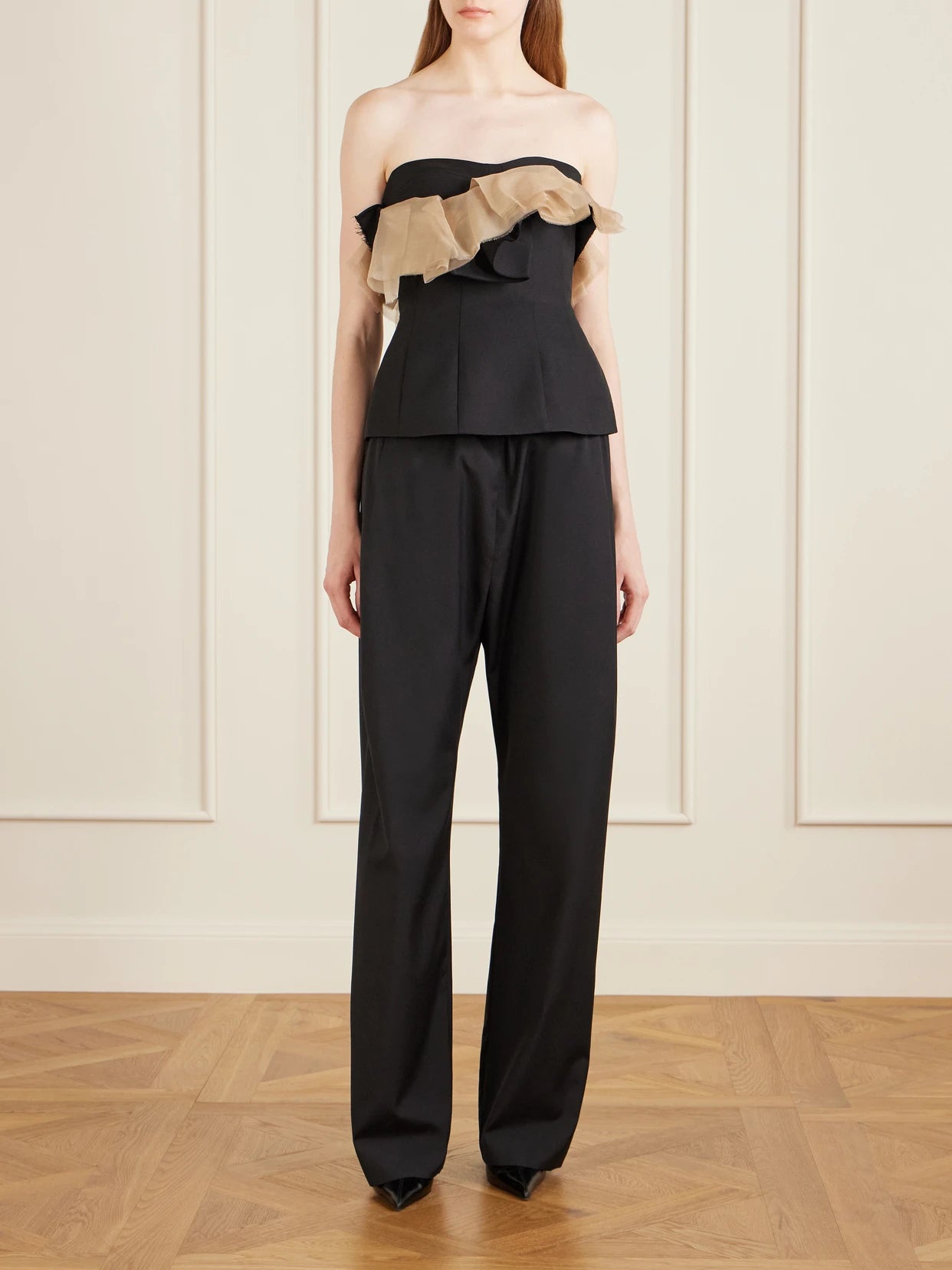 Image of a model wearing Pants. Product name - Rohen Wool Pants in Black colour by brand - KHAITE