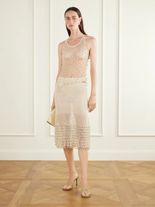 Image of a model wearing Tops. Product name - Lilian Embellished Cotton Crochet-knit Halterneck Top in Cream colour by brand - Yoshita 1967