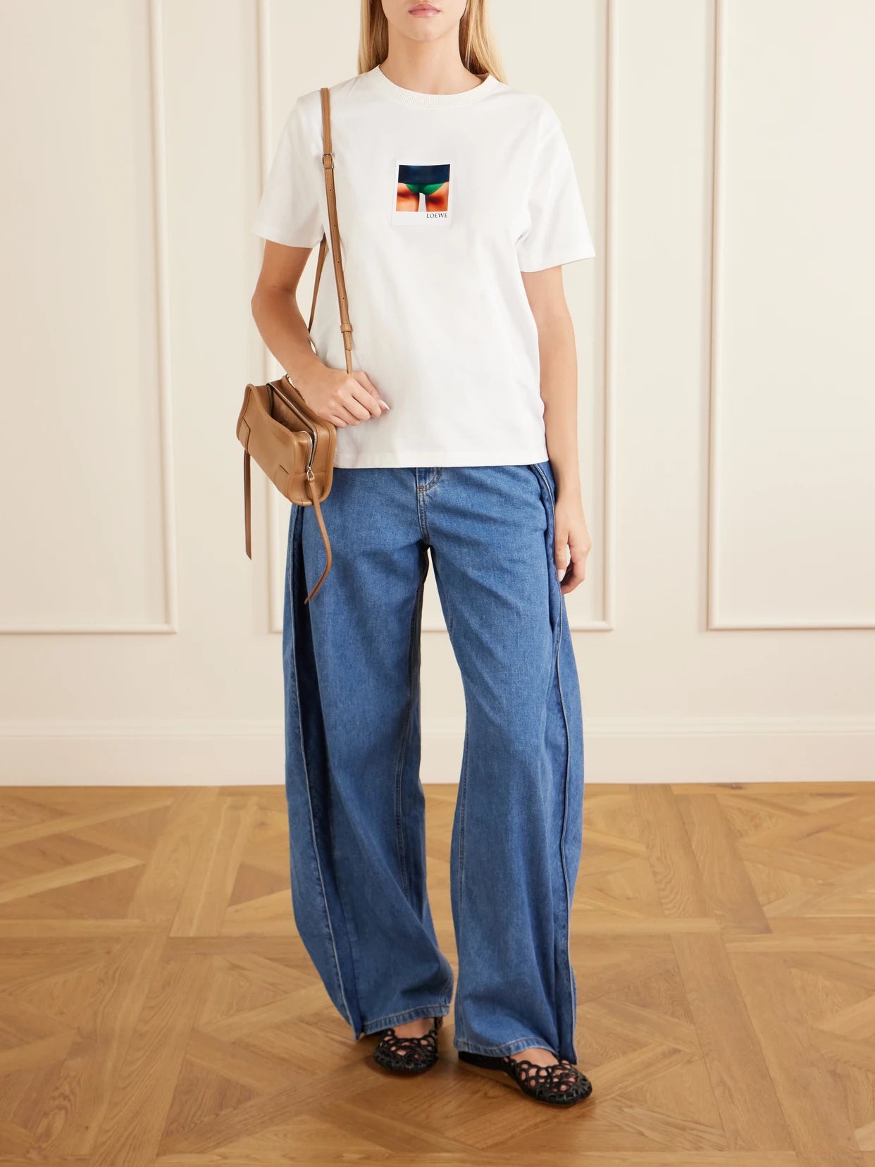 Image of a model wearing Tops. Product name - Appliquéd Cotton-jersey T-shirt in White colour by brand - LOEWE