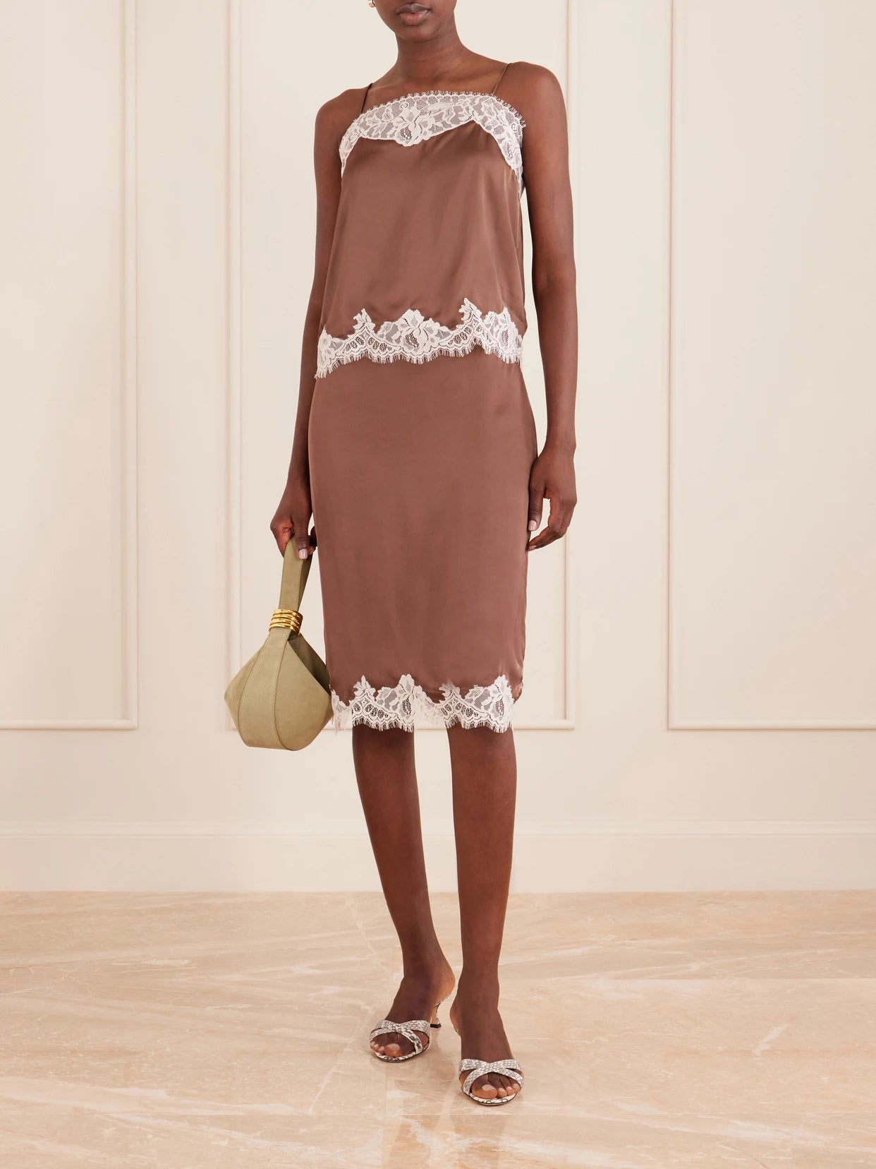 Image of a model wearing Skirts. Product name - Marisol Lace-trimmed Satin Midi Skirt in Chocolate colour by brand - Faithfull