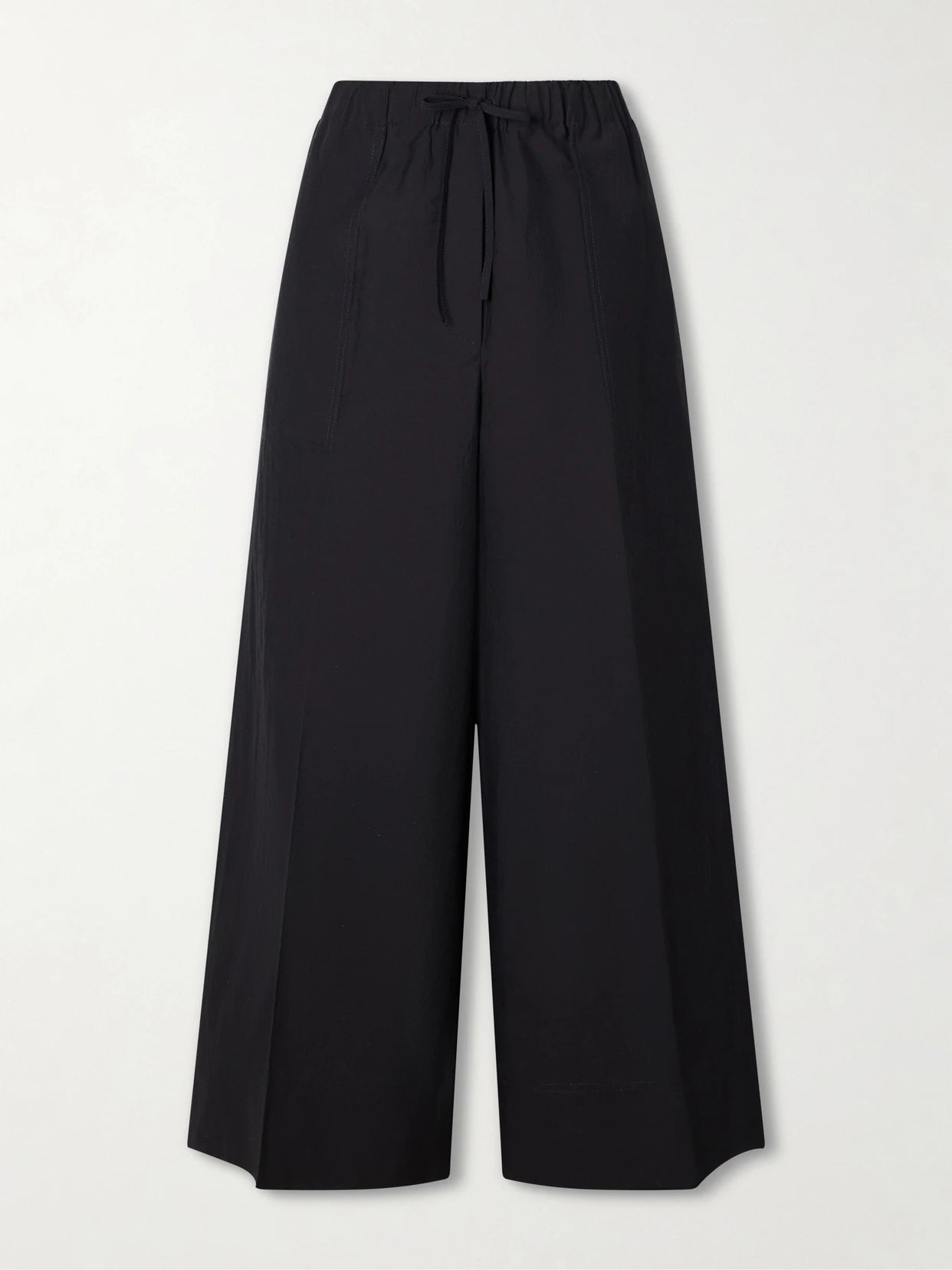 Image of a model wearing Pants. Product name - Wide Summer Cotton-blend Wide-leg Pants in Black colour by brand - TOTEME